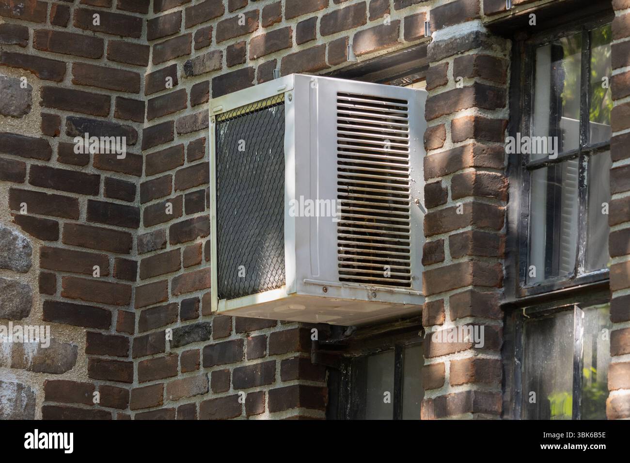 exterior view of air conditioning window unit installed in a vertical ...