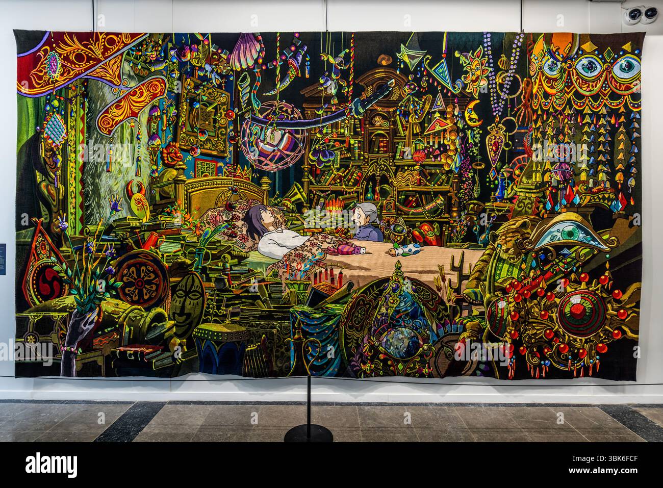 Tapestry "Old Sophie at Howl's Bedside" from the series "The Imagination of Hayao Miyazaki captured in Aubusson Tapestry" in the exhibition rooms of the Cité internationale de la tapisserie. The tapestry measures 3 metres x 5.60 metres. It was woven in Aubusson from February 2022 to October 2023. Rue Williams Dumazet, Aubusson, Nouvelle-Aquitaine, France Stock Photo