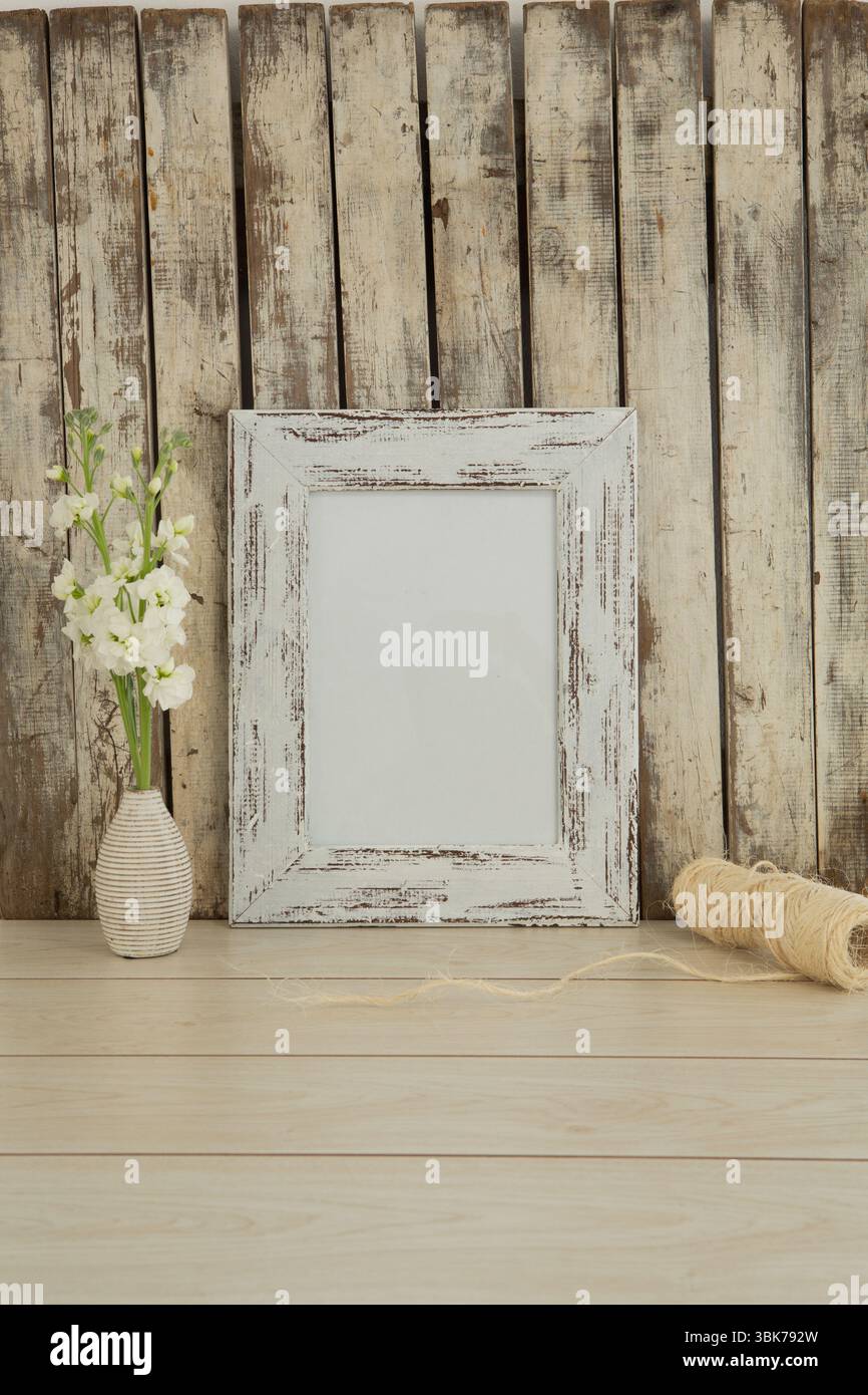 Photo frame and flower vase on table Stock Photo
