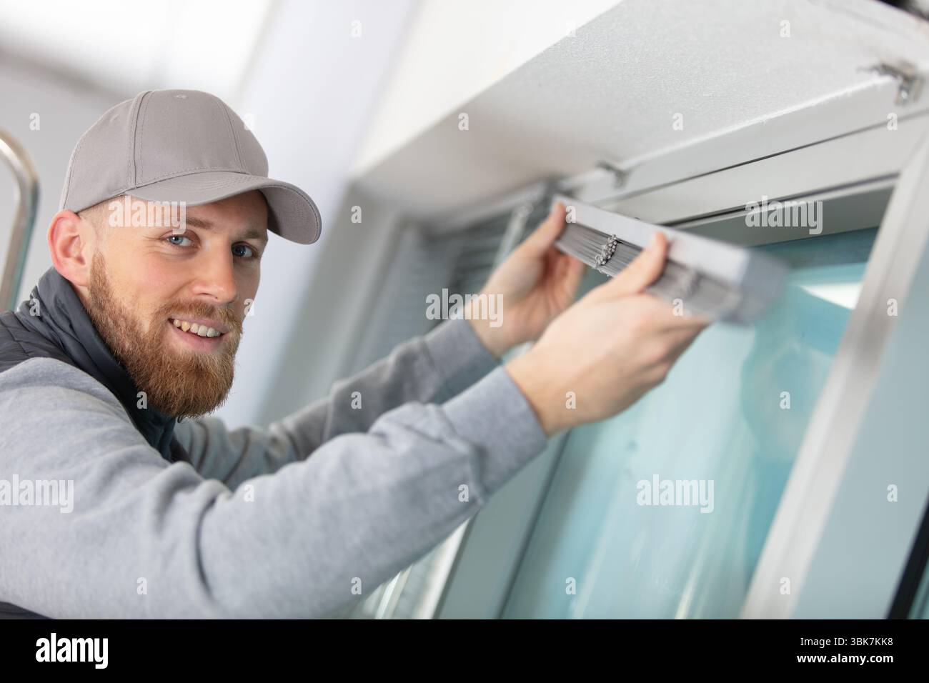 young man installing window blinds Stock Photo