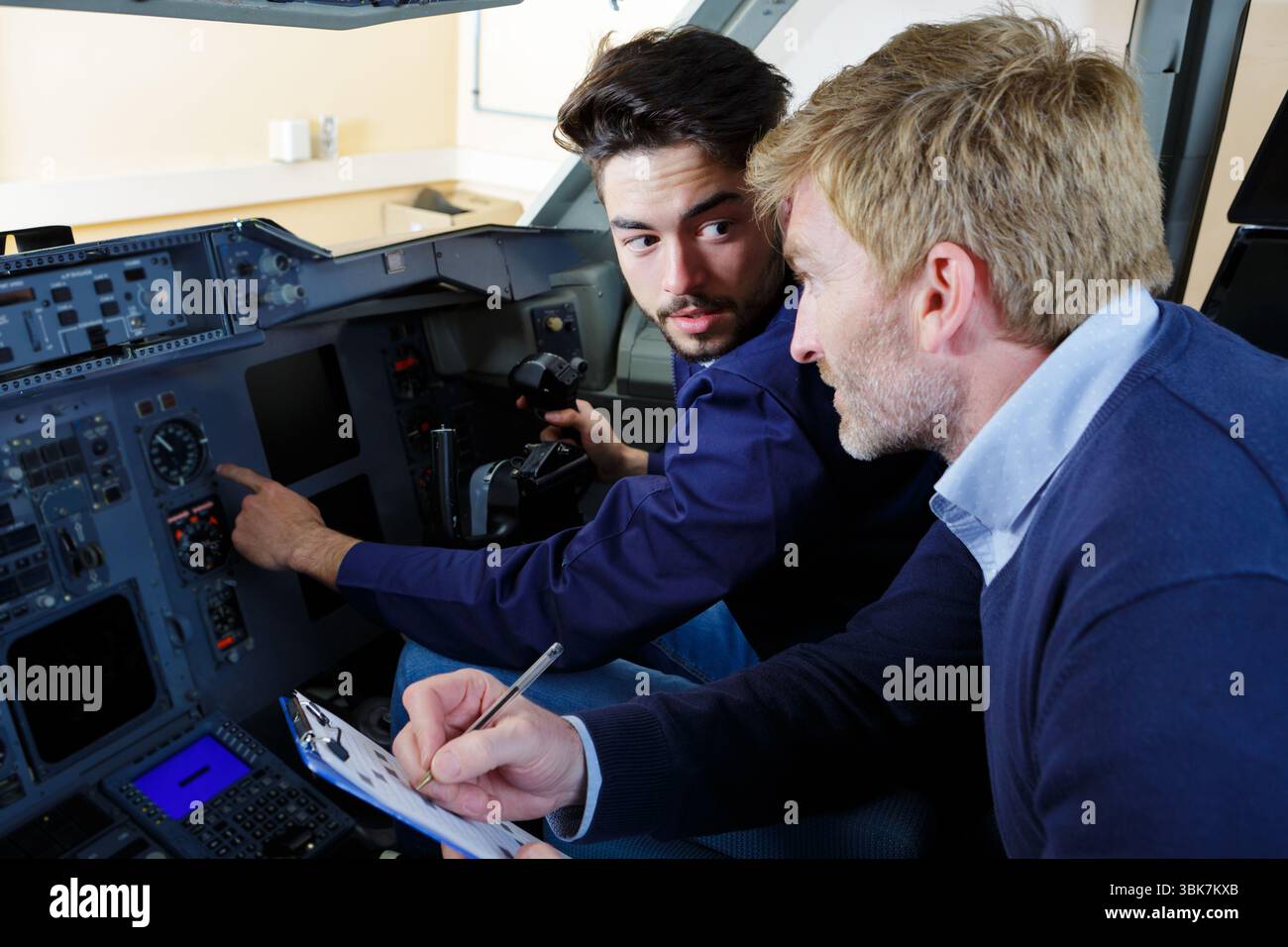 engineers working in plane cockpit Stock Photo