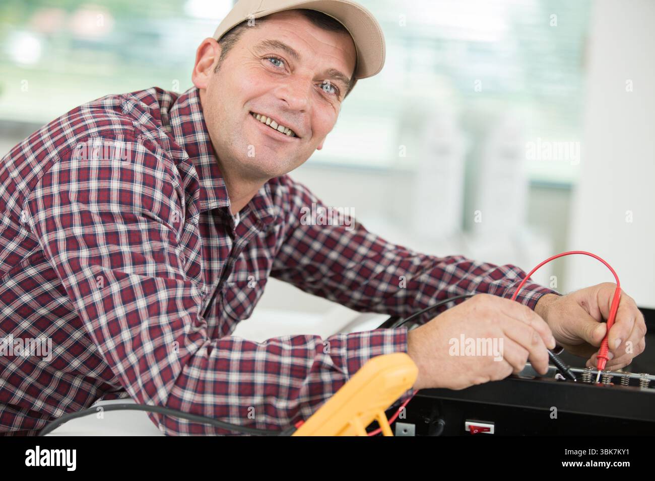 portrait of worker using multimeter Stock Photo