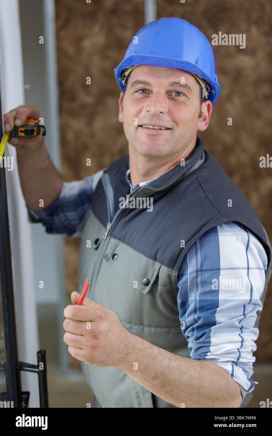 happy experienced man measuring window Stock Photo - Alamy