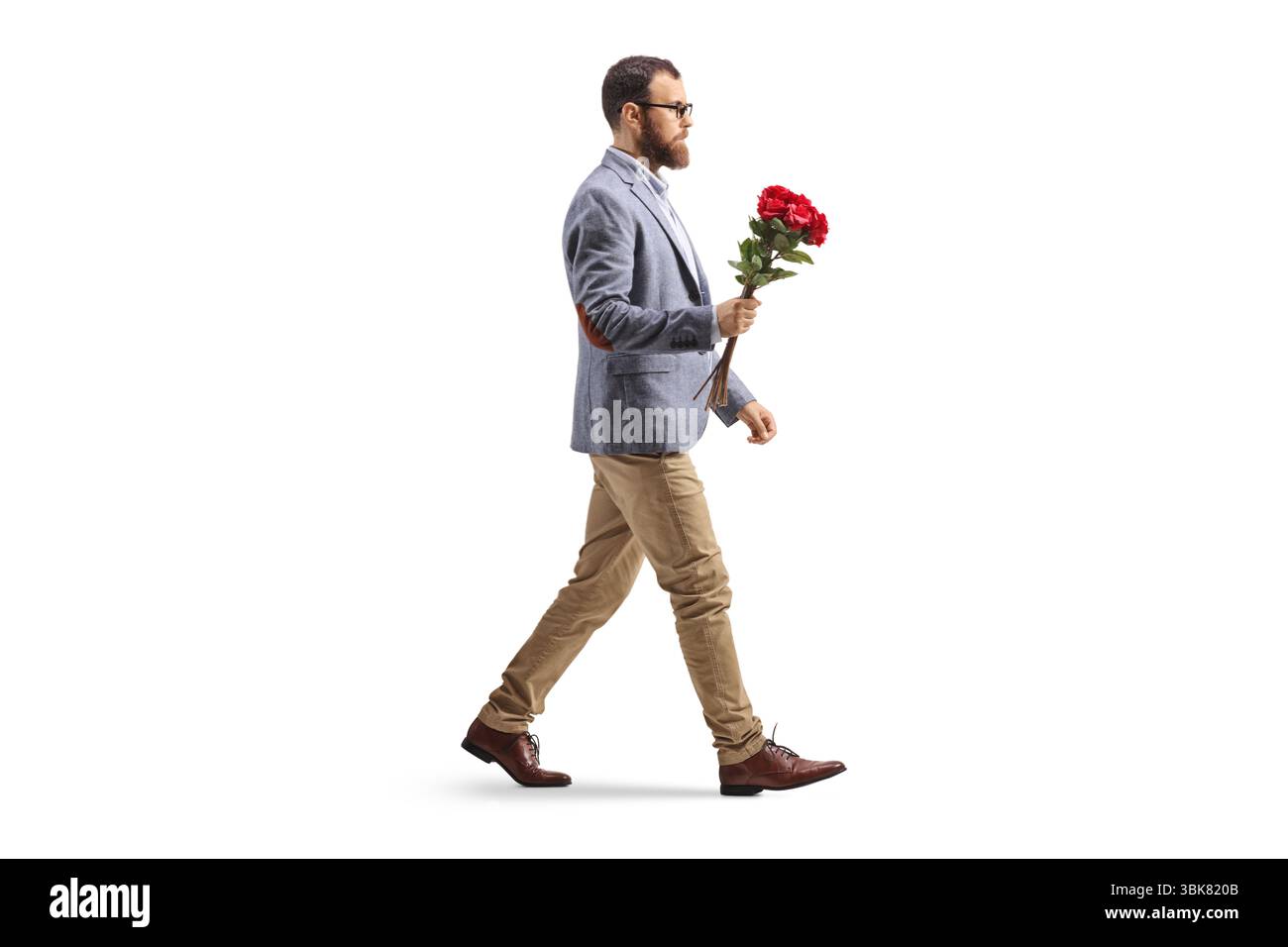 Bearded man walking with a bunch of red roses isolated on white background Stock Photo