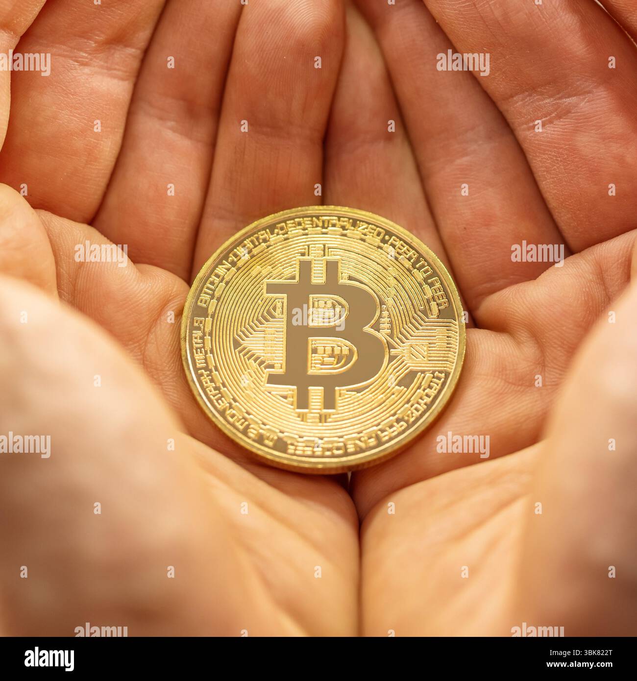 Closeup of physical bitcoin in a hand Stock Photo - Alamy