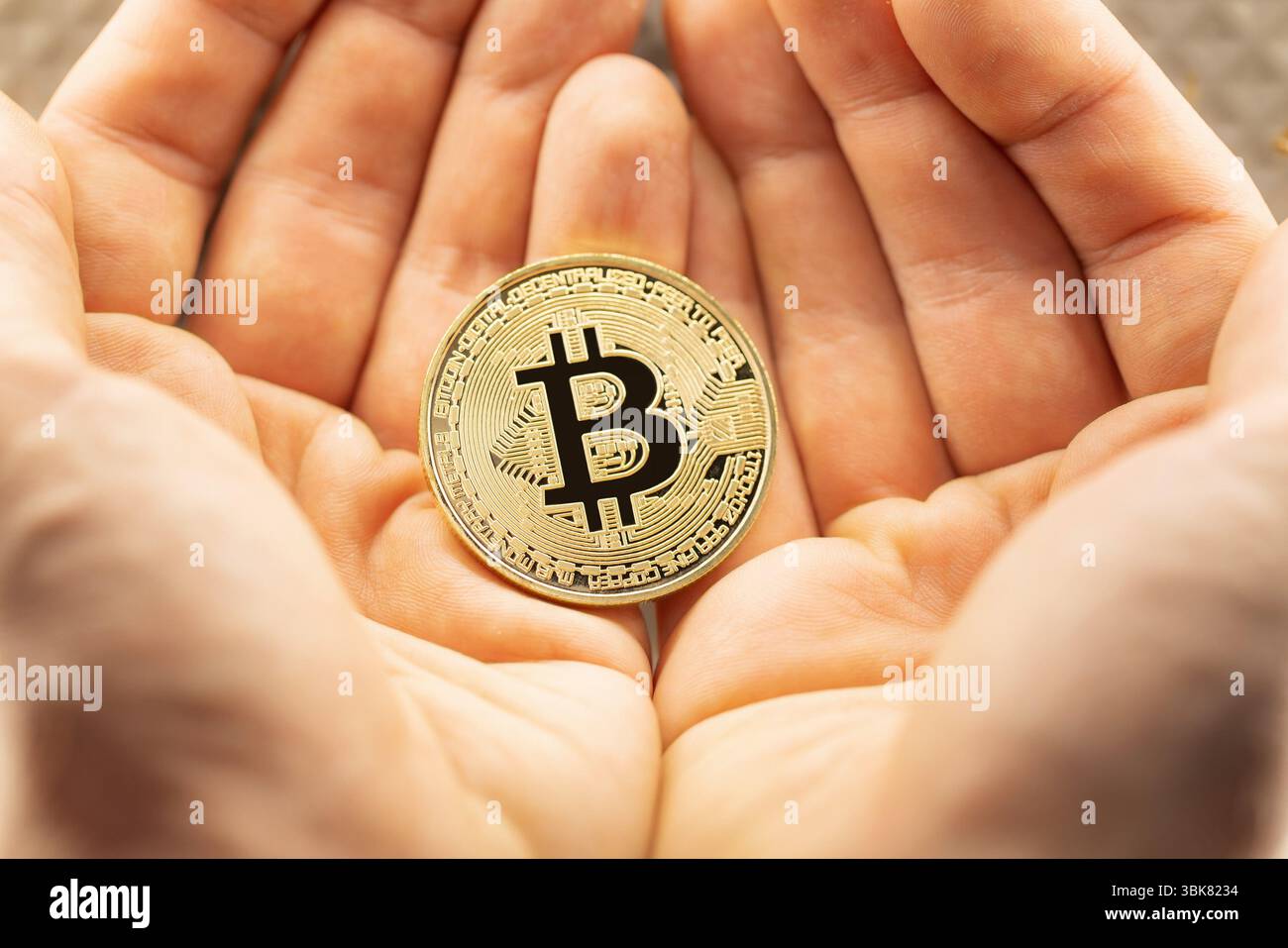 Bitcoin physical coin held in hand Stock Photo - Alamy