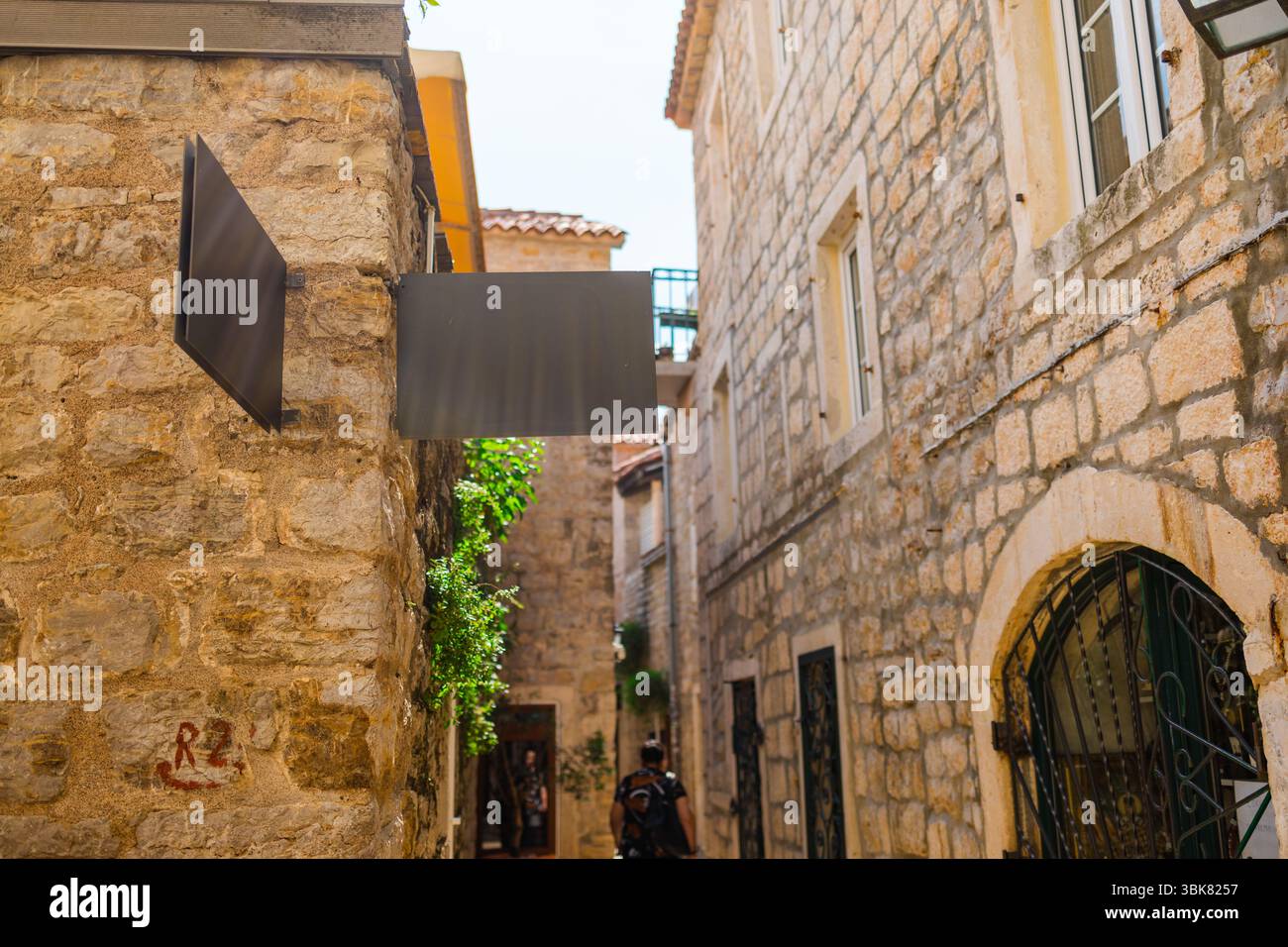 Blank signboard on stone building wall in Mediterranean alley. Concept ...