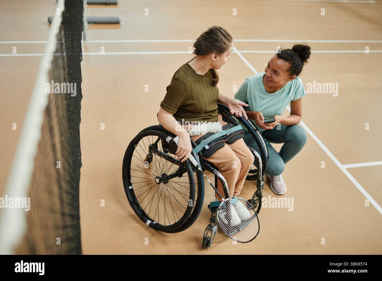 Woman in Wheelchair Talking to Friend Stock Photo - Alamy