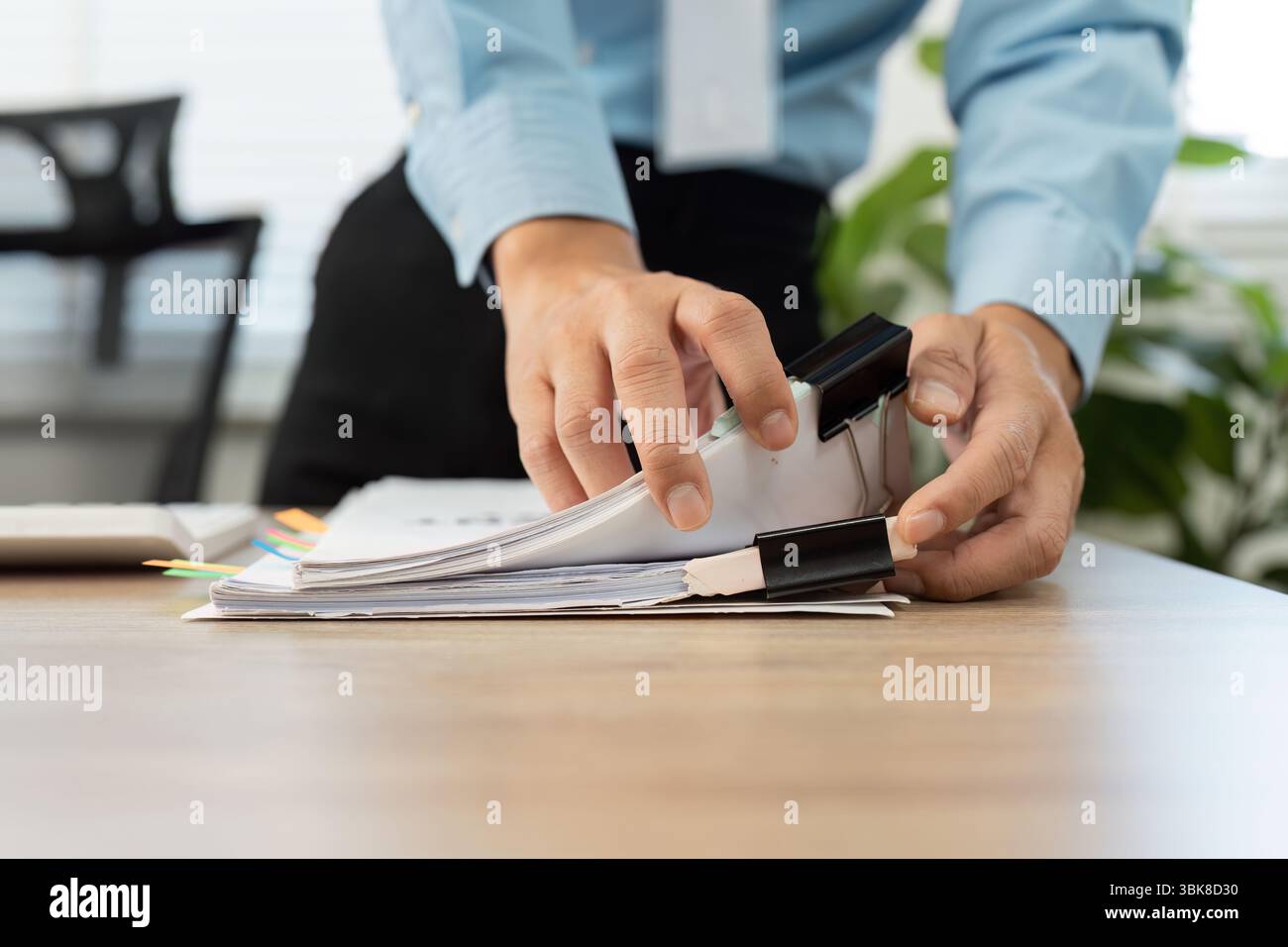 Document Organization and Management. Professional organizing paperwork with binder clips. Stock Photo