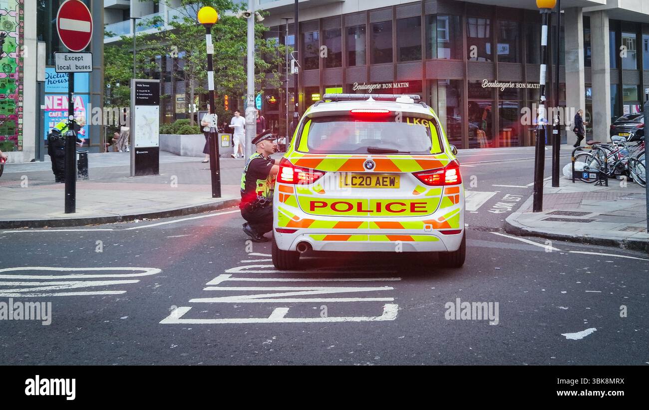 London, UK - July 23, 2024: United Kingdom Police car on a London city street at Finsbury Park. - Smartphone Captured Stock Image