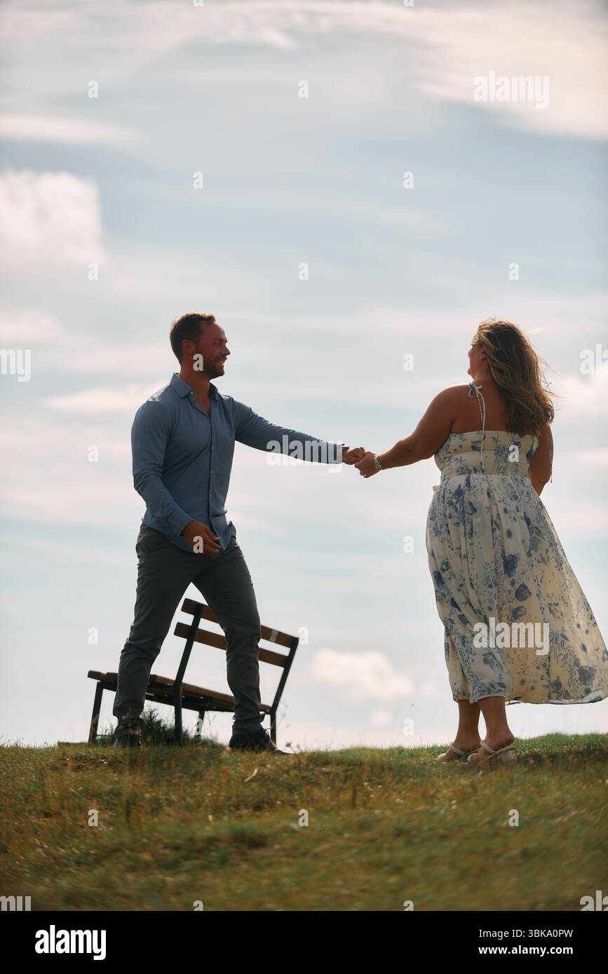 Romantic couple dancing outdoors on mountain field Stock Photo - Alamy