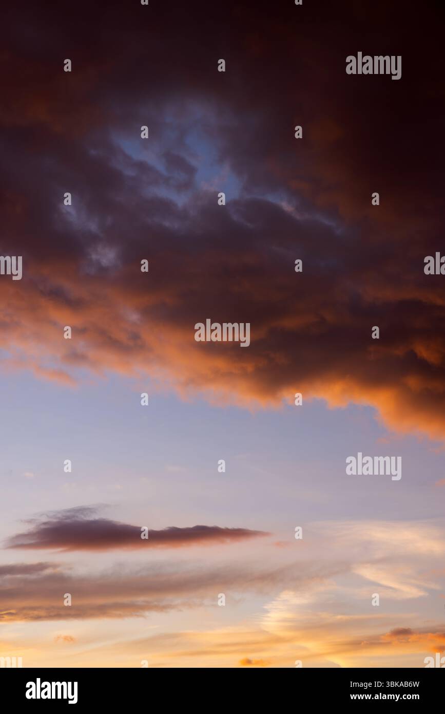 Dramatic sky with orange and dark clouds after storm Stock Photo