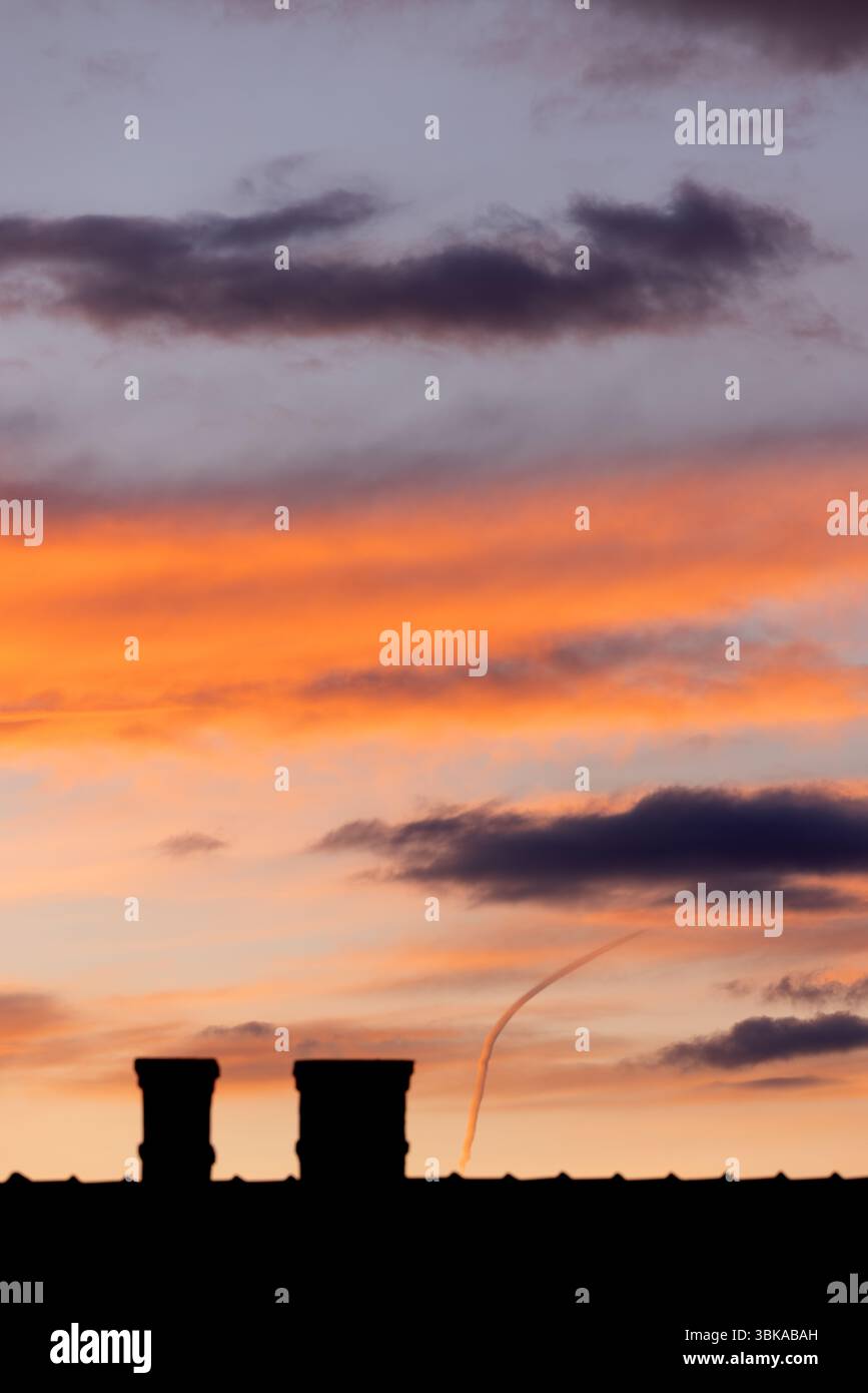 Dramatic sky with orange and dark clouds after storm Stock Photo