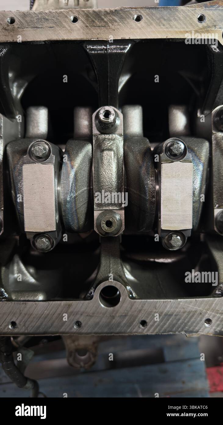 Exposed internal parts of a car engine showing crankshaft and connecting rods in detail. Stock Photo