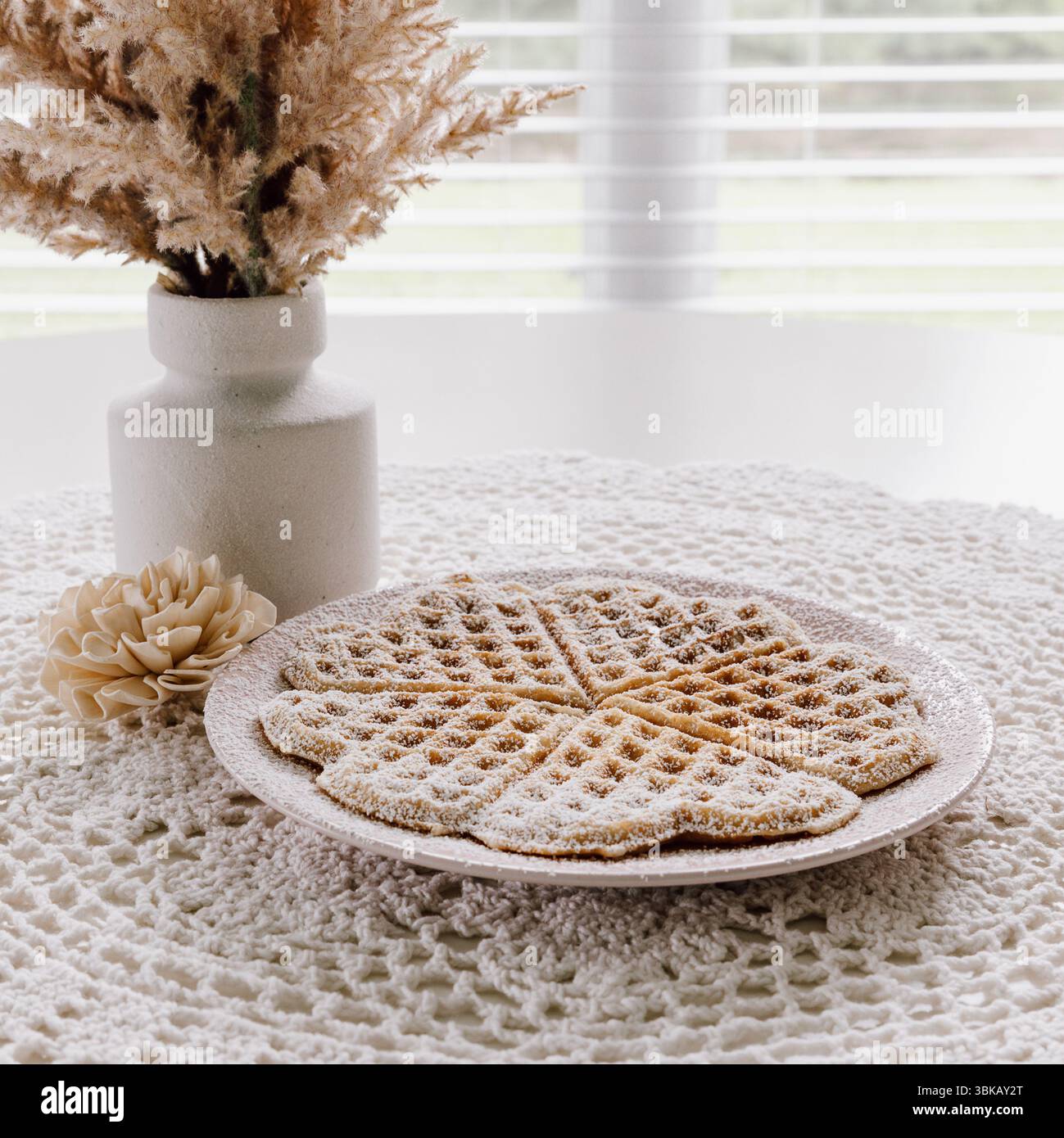 Scandinavian Style Breakfast Scene with Homemade Heart Shaped Waffles and Powdered Sugar Stock Photo