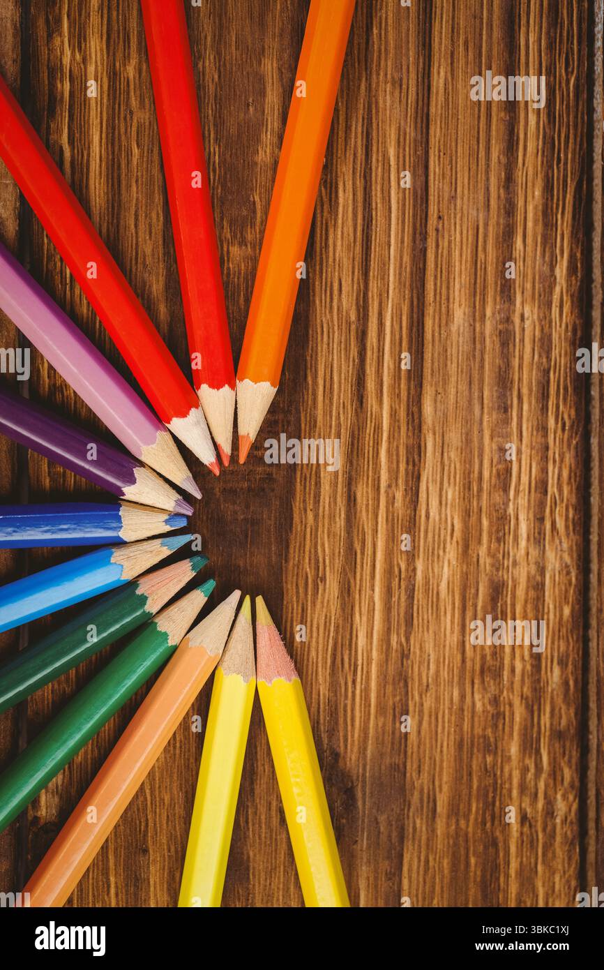 Color pencils arranged on wooden table Stock Photo