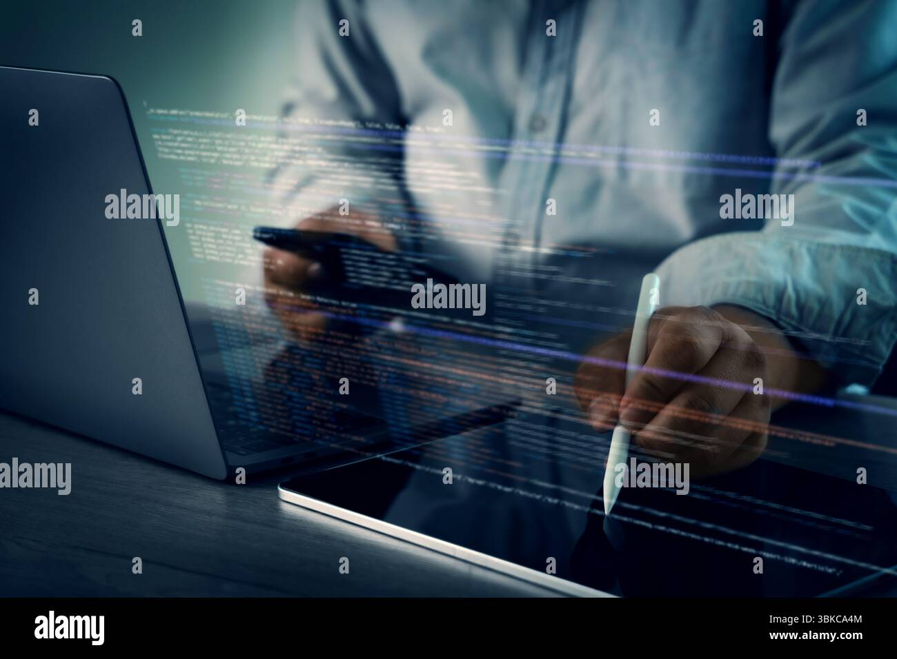 A programming code on representing person working laptop with digital code and tablet, using stylus, modern workspace, focused technology Stock Photo