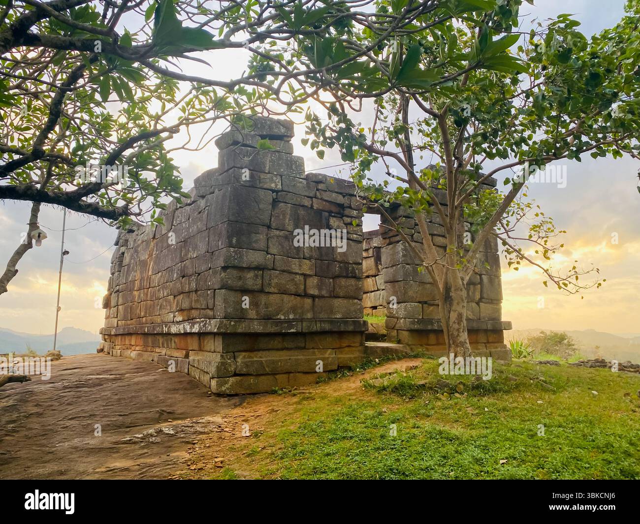 Sunset over the ancient stone ruins of Dewanagala Raja Maha Viharaya in Mawanella, Sri Lanka. This sacred heritage site highlights the timeless beauty - Smartphone Captured Stock Image