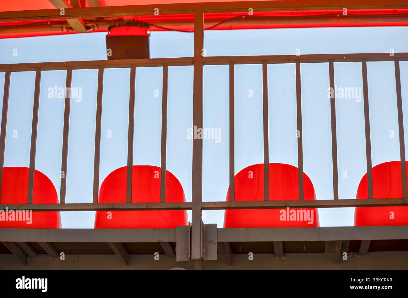 Metail Red Railing A metal railing with red chairs on it. The chairs are red and ar Stock ...
