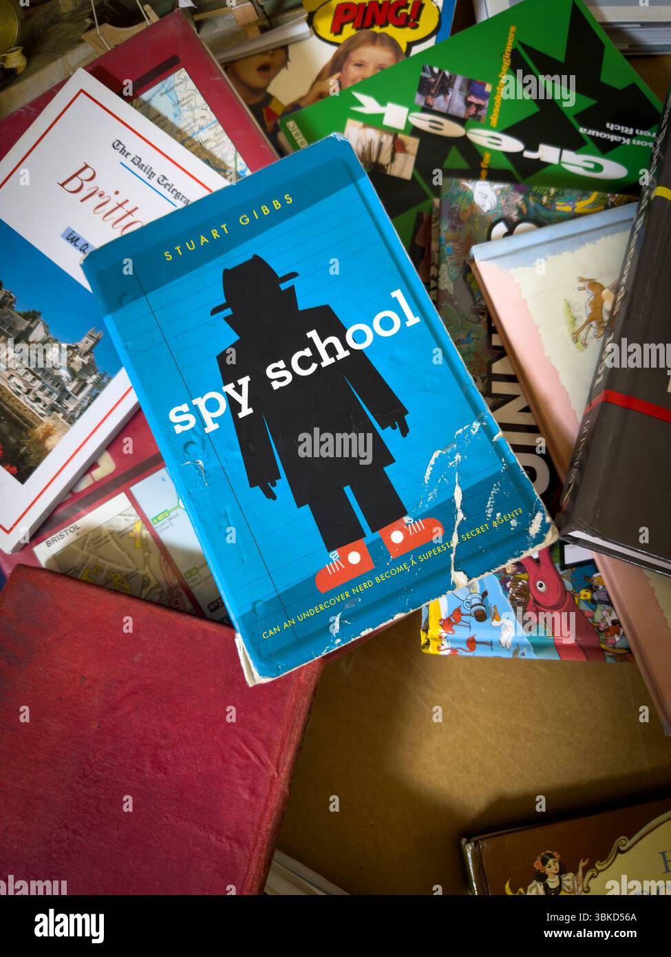 19 June 2025 - Cambridge, UK - A Spy School book standing out in a pile ...