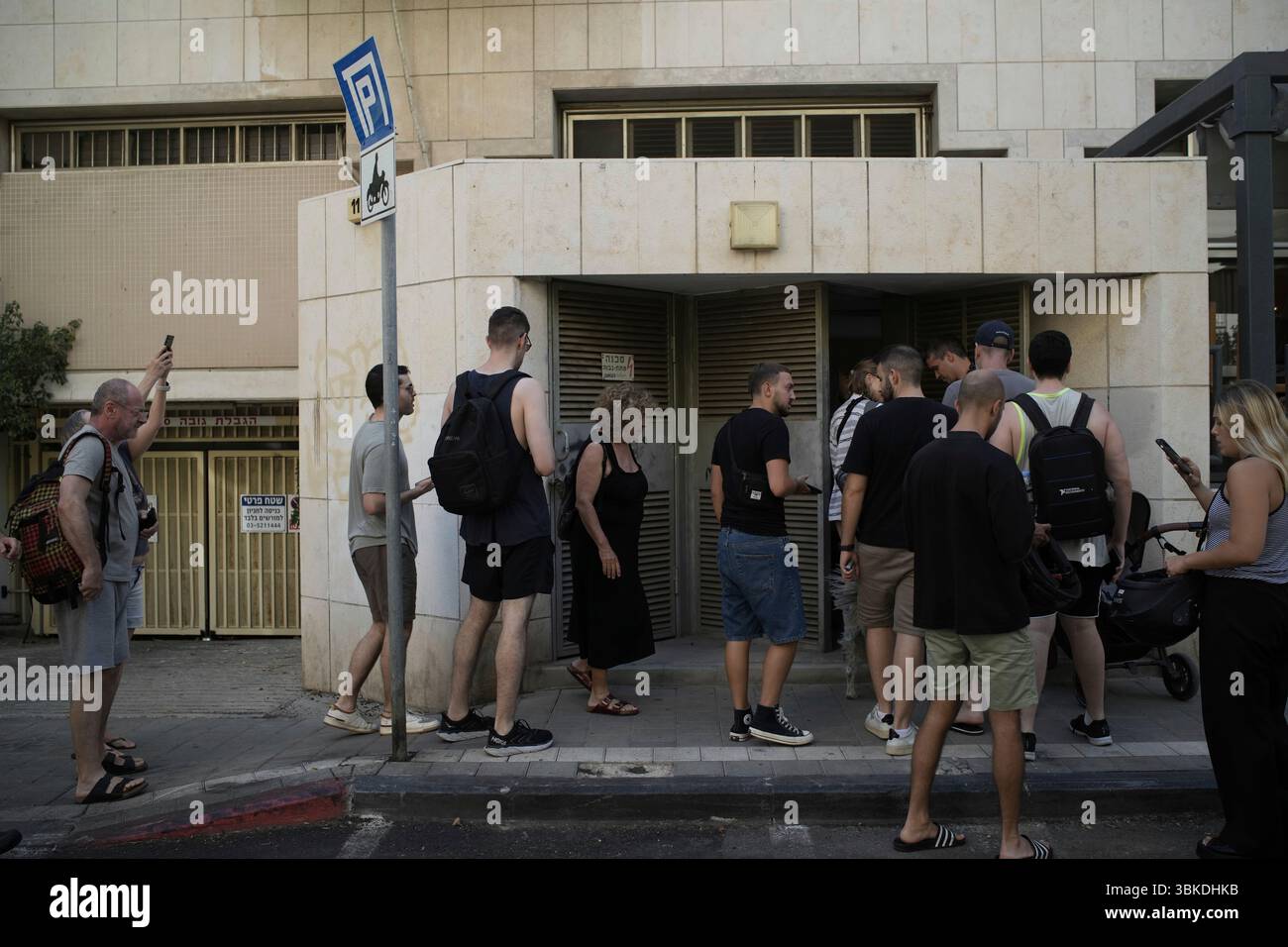 People enter a shelter during air raid sirens warning of incoming