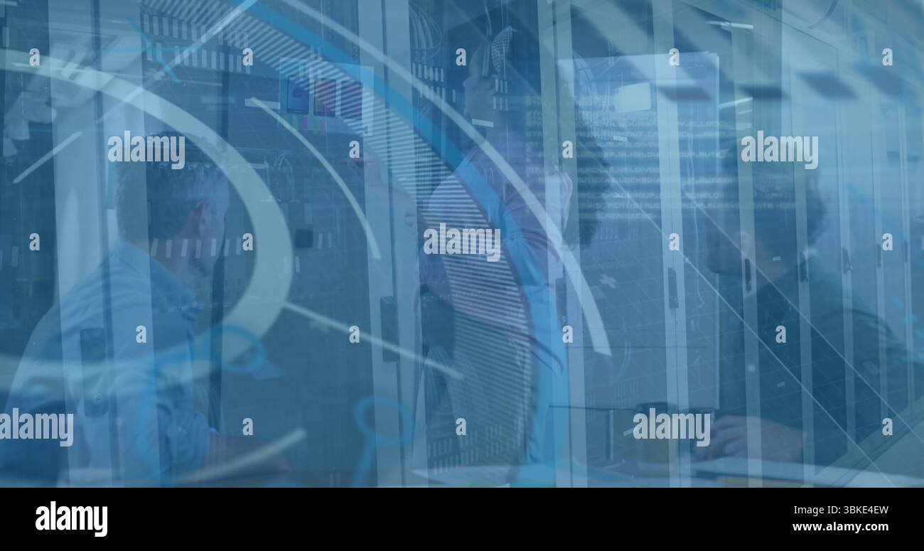 Collaborating IT professionals analyzing data overlays at glass server racks worktable with laptop Stock Photo