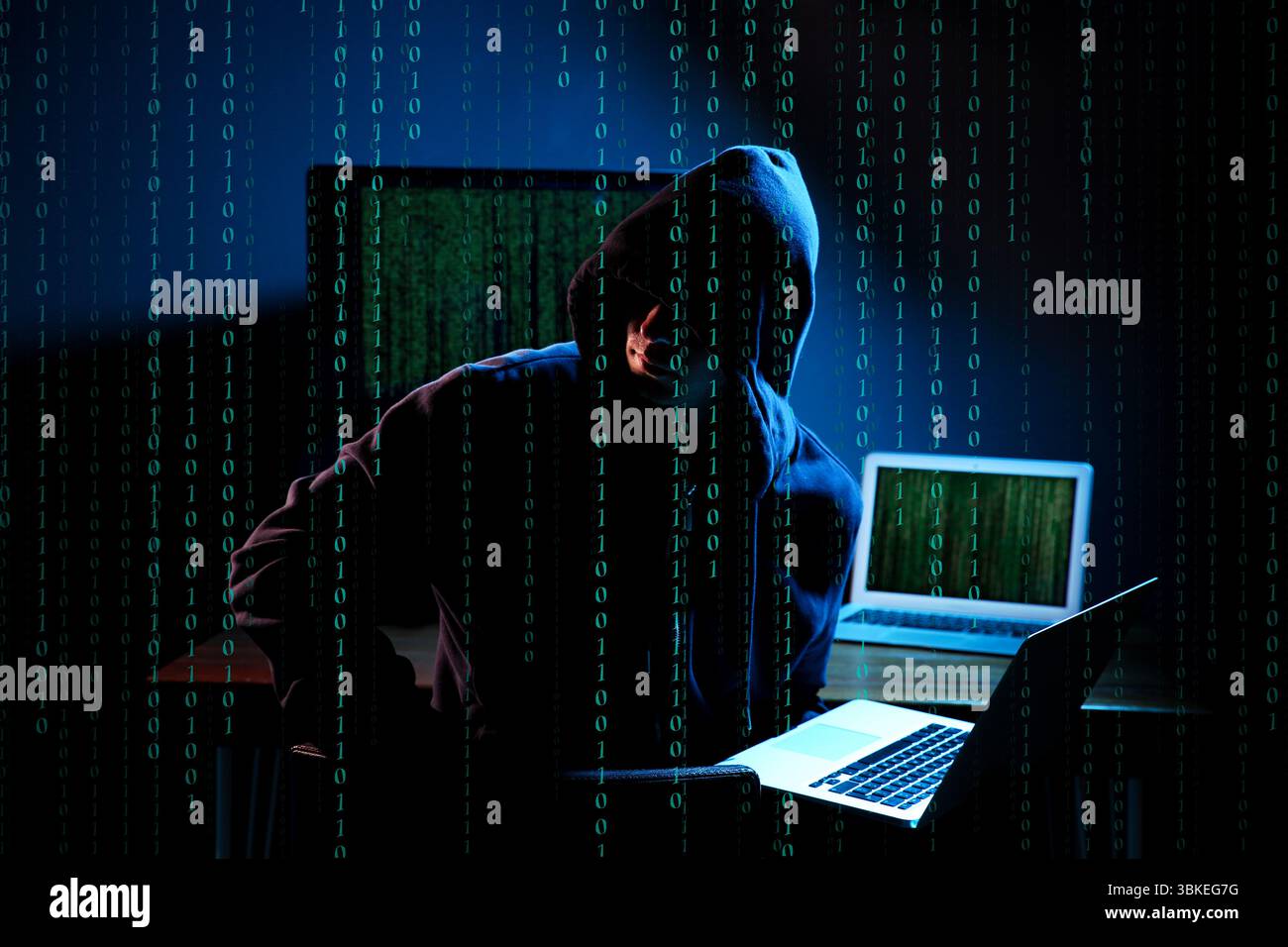 Cyber attack. Hacker working on computers in dark room. Binary code around him Stock Photo