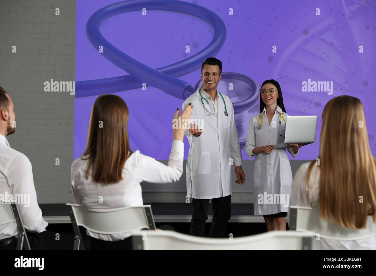 A pharmaceutical sales representative presenting to a group of healthcare professionals