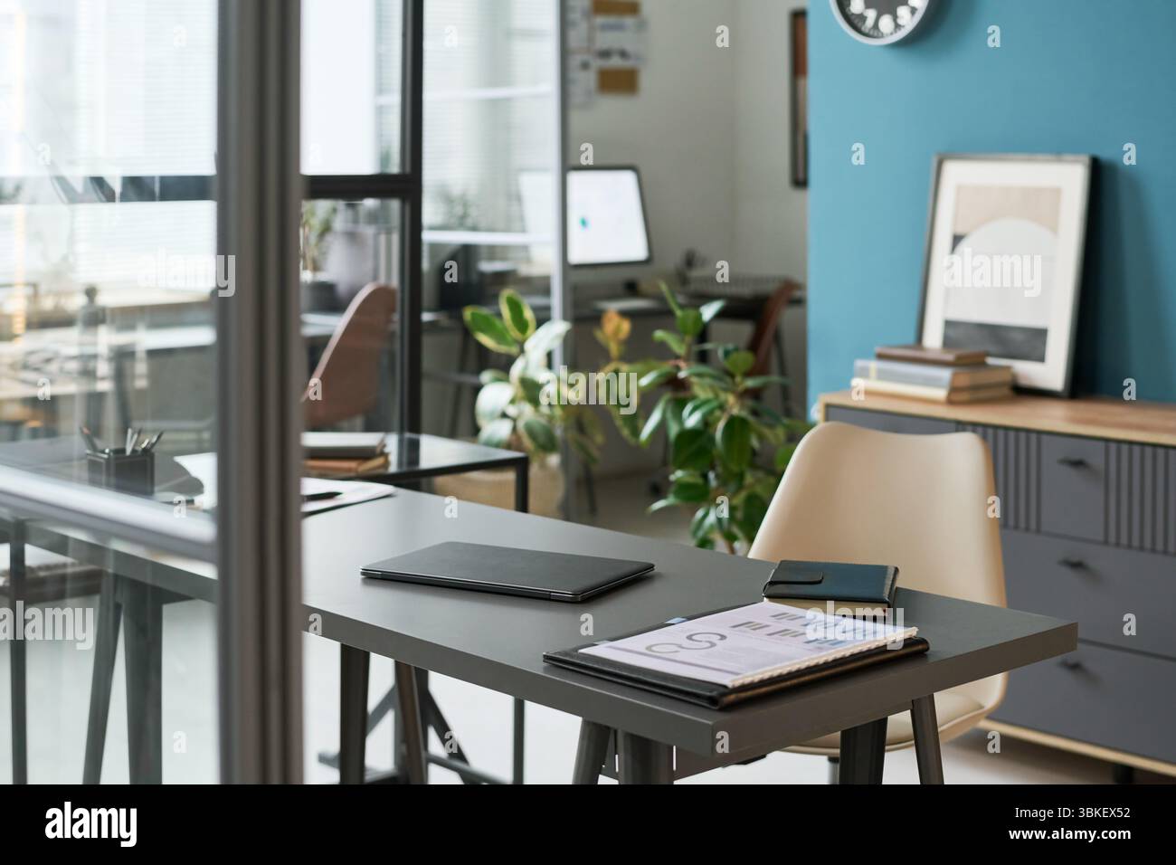 Modern Retirement Studio Office Interior Featuring Desk and Digital Devices Stock Photo