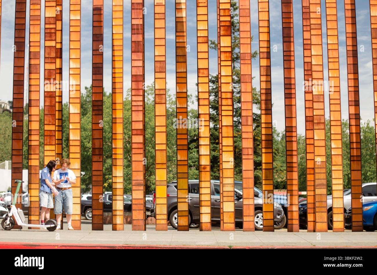 Giant art wooden straws line the walkway for pedestrians. Stock Photo