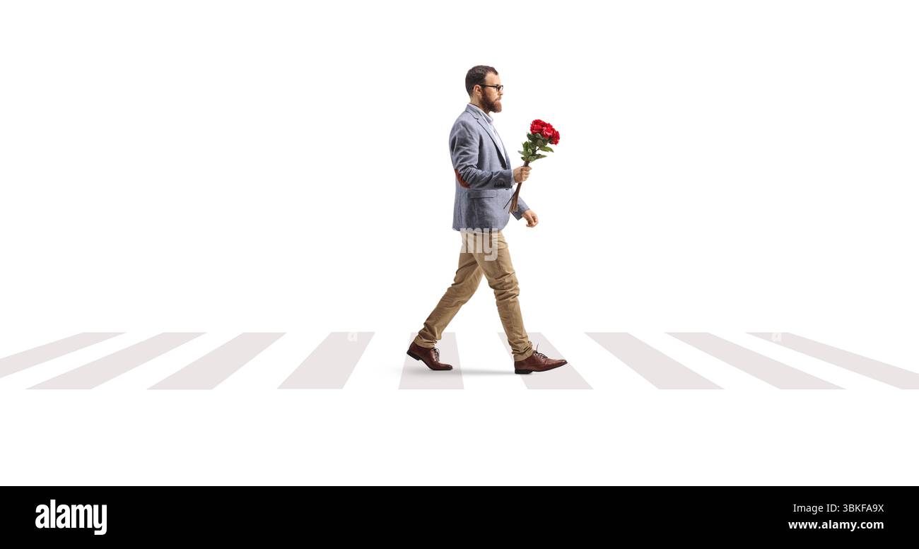 Bearded man crossing a street with a bunch of red roses isolated on white background Stock Photo