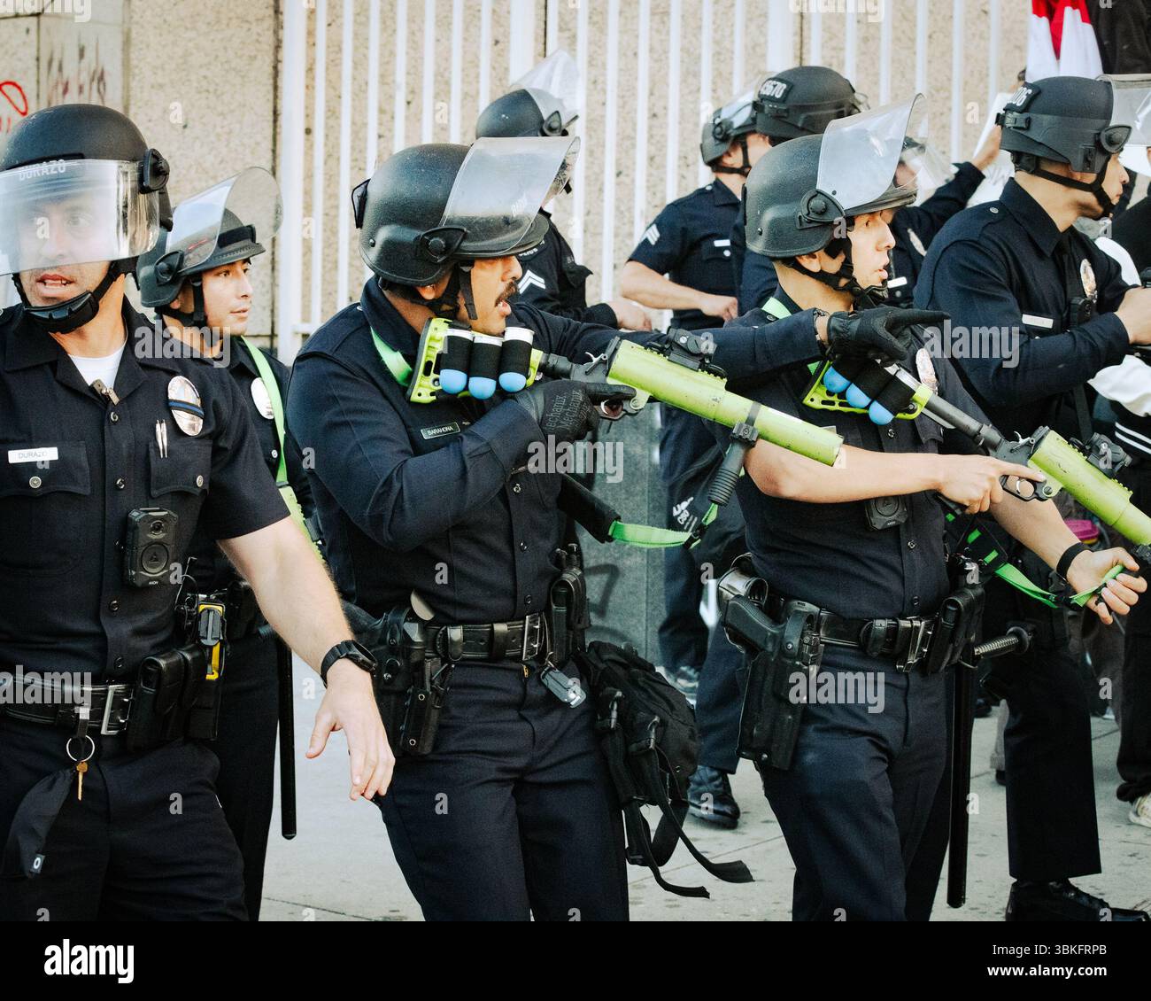 Los Angeles Police Department officers in full riot gear aim less ...