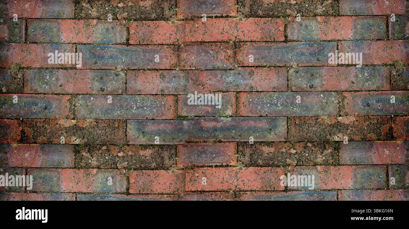 weathered brick wall is appearing in flat design, featuring red bricks with moss patches Stock Photo