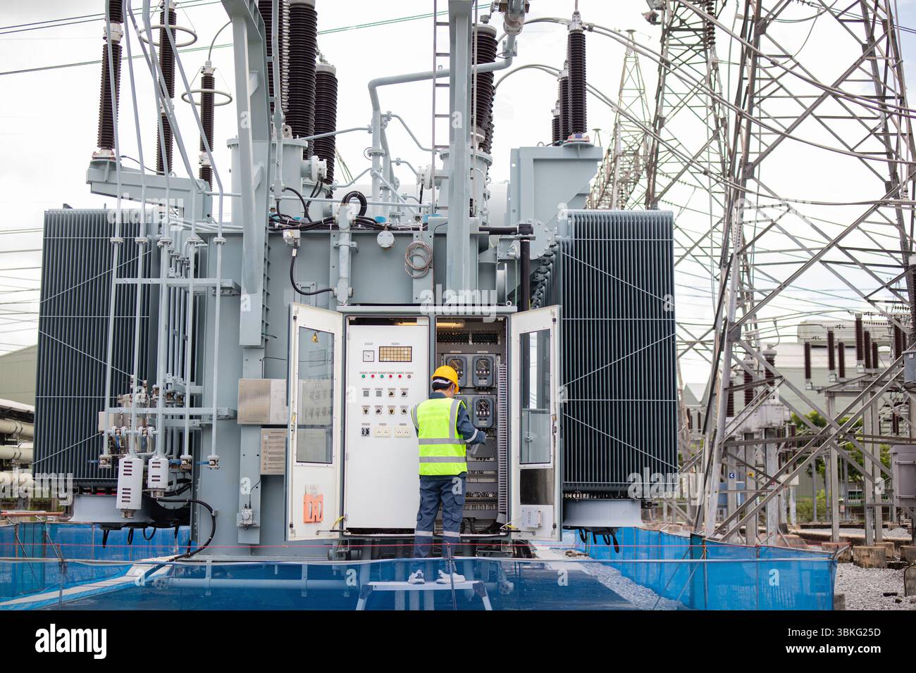 Transformer Visual Inspection An engineer performs inspection on large transformer at electrical ...