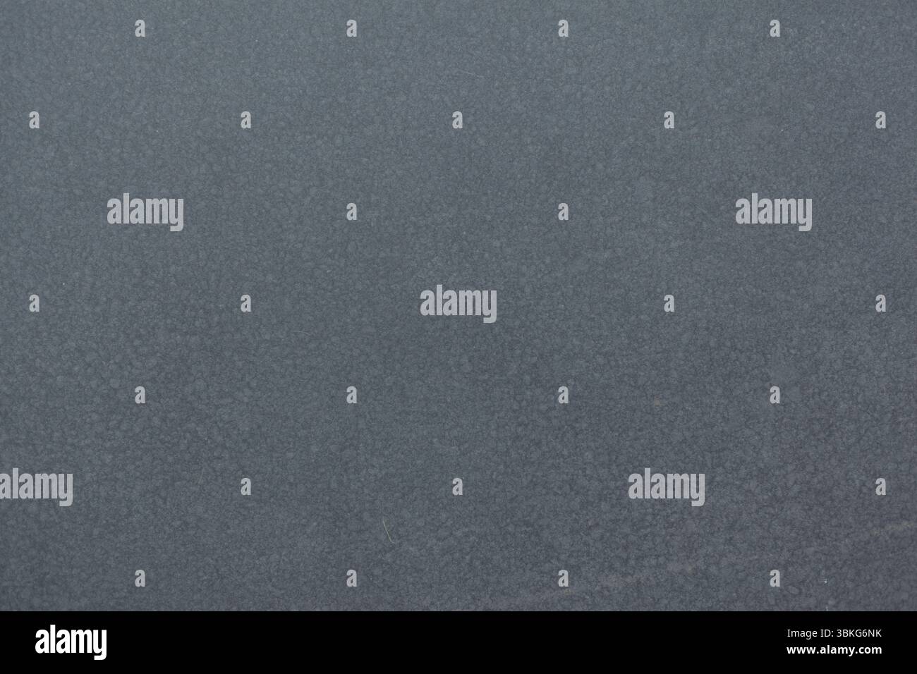 Textured grey surface is filling flat design canvas, showing subtle granular patterns throughout Stock Photo