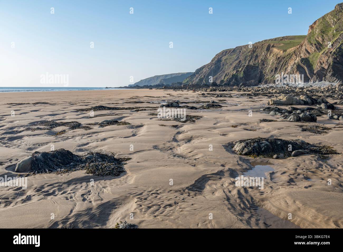 Shadow patterns from evening light on Cornwall beach near Sandymouth Stock Photo