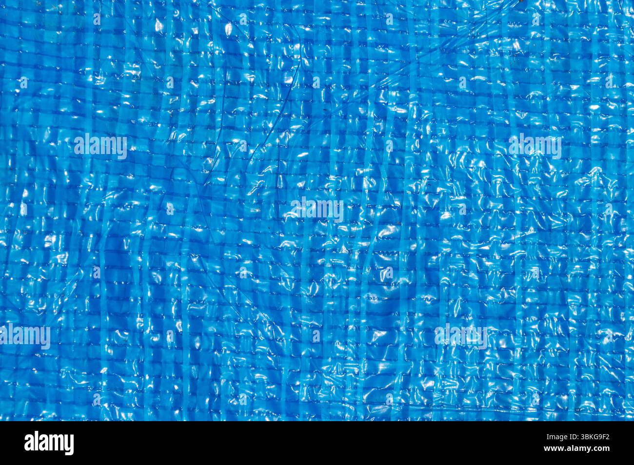Blue woven plastic tarp texture close-up full frame. Stock Photo