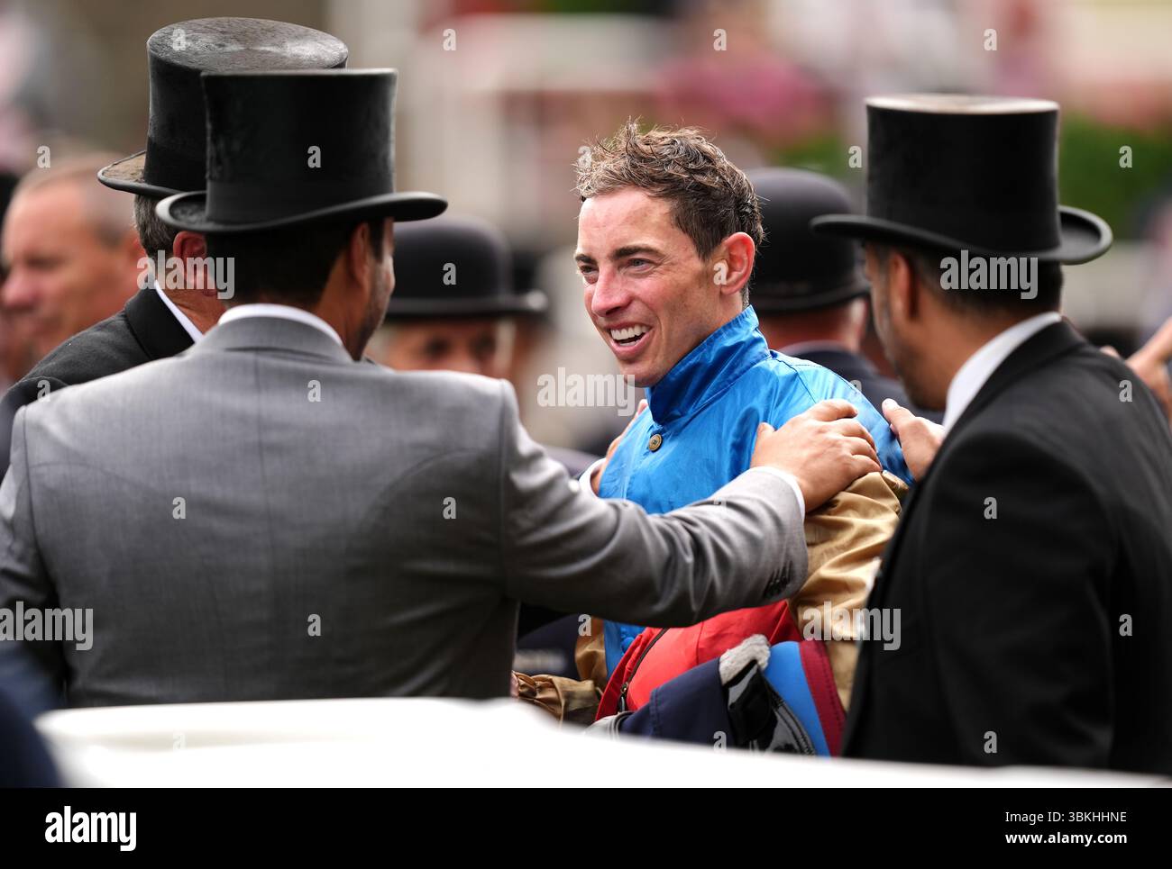 Jockey James Doyle (centre) in the winners encloser after victory in ...