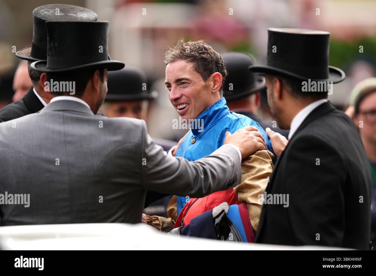 Jockey James Doyle (centre) in the winners encloser after victory in ...
