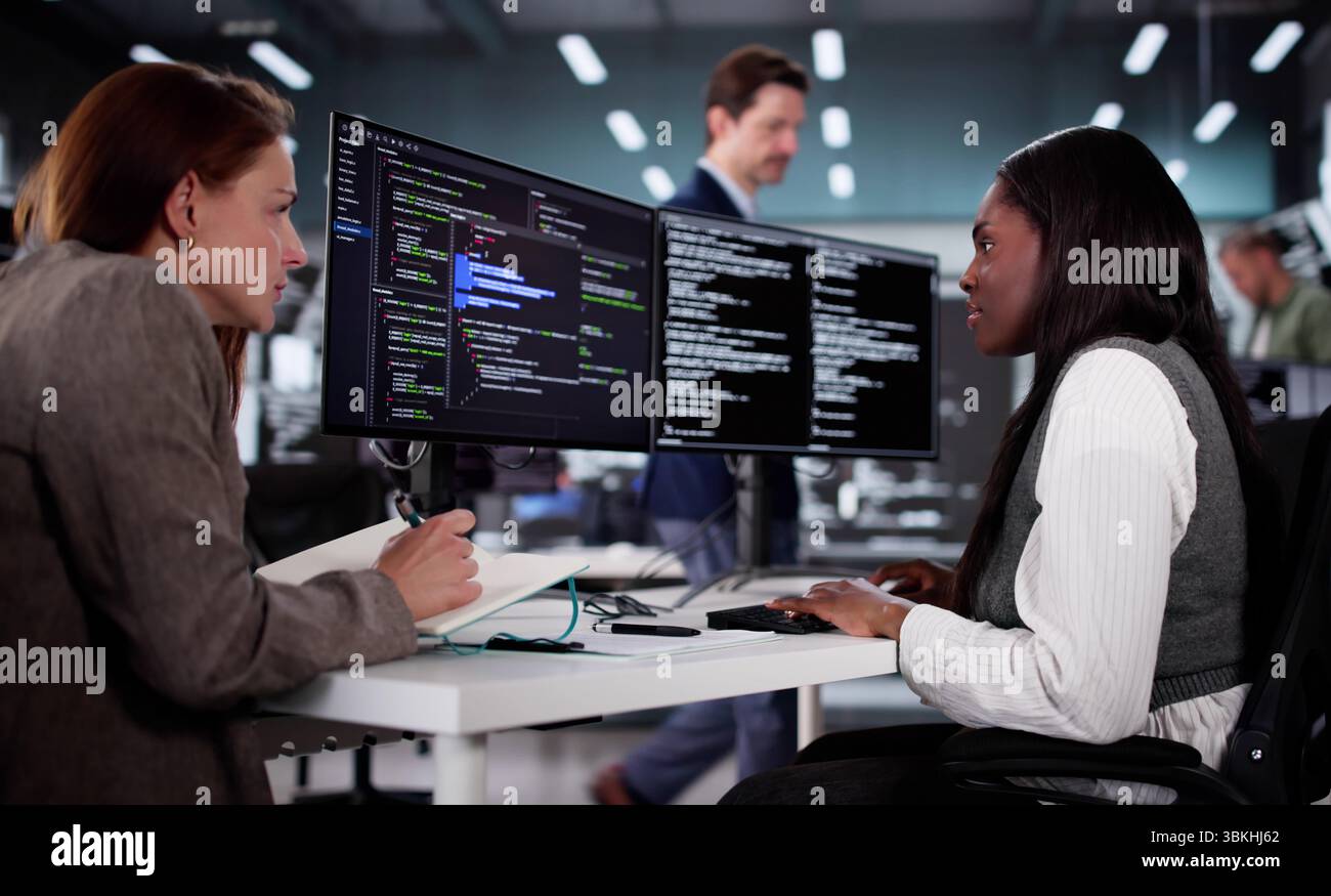 Tech-savvy African Engineer Developing Innovative Software With Diverse Team. Stock Photo