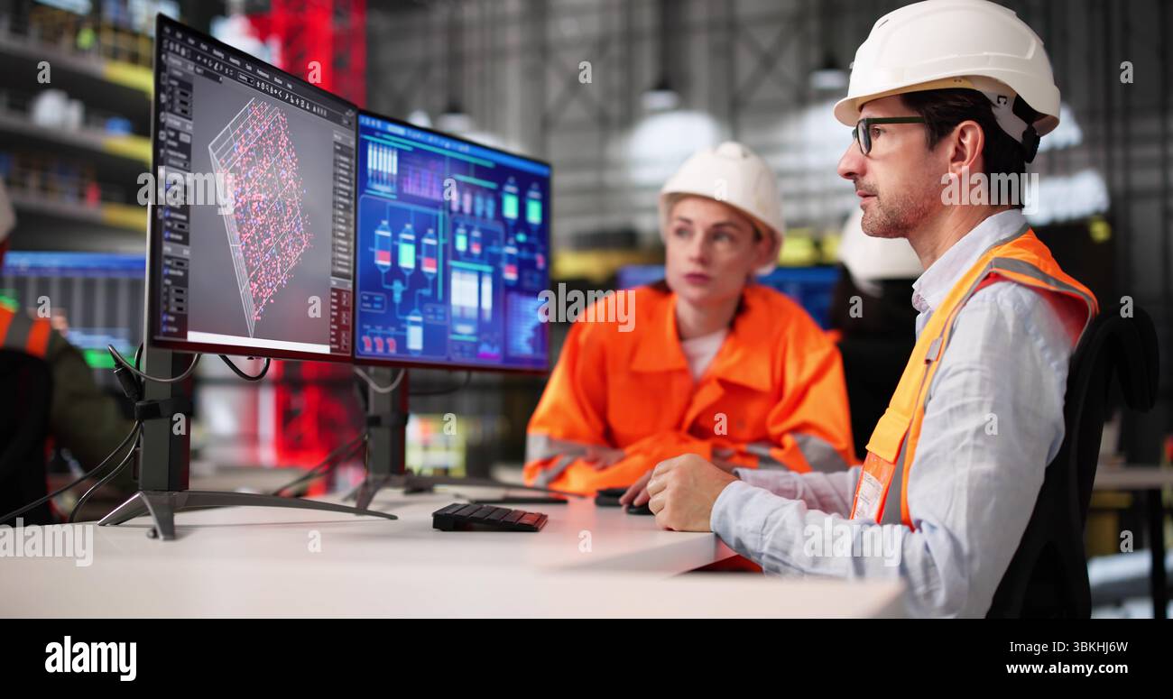 Young Black Engineer Using SCADA Software At Industrial Construction Site. Diverse Group Stock Photo