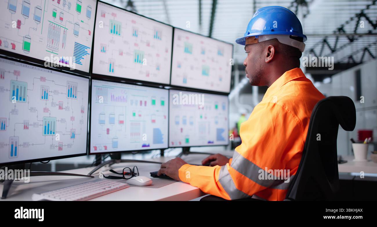 African-American Engineer Monitors Plant Process Using Modern SCADA Technology. Stock Photo