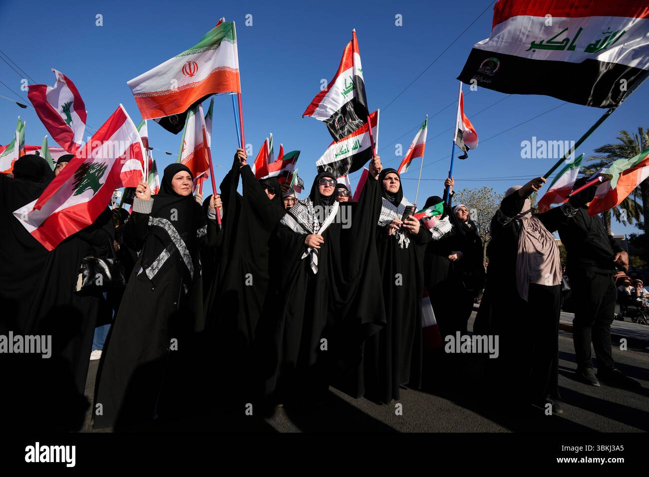 Shiite women, chant slogans against the U.S. and Israel during a rally ...