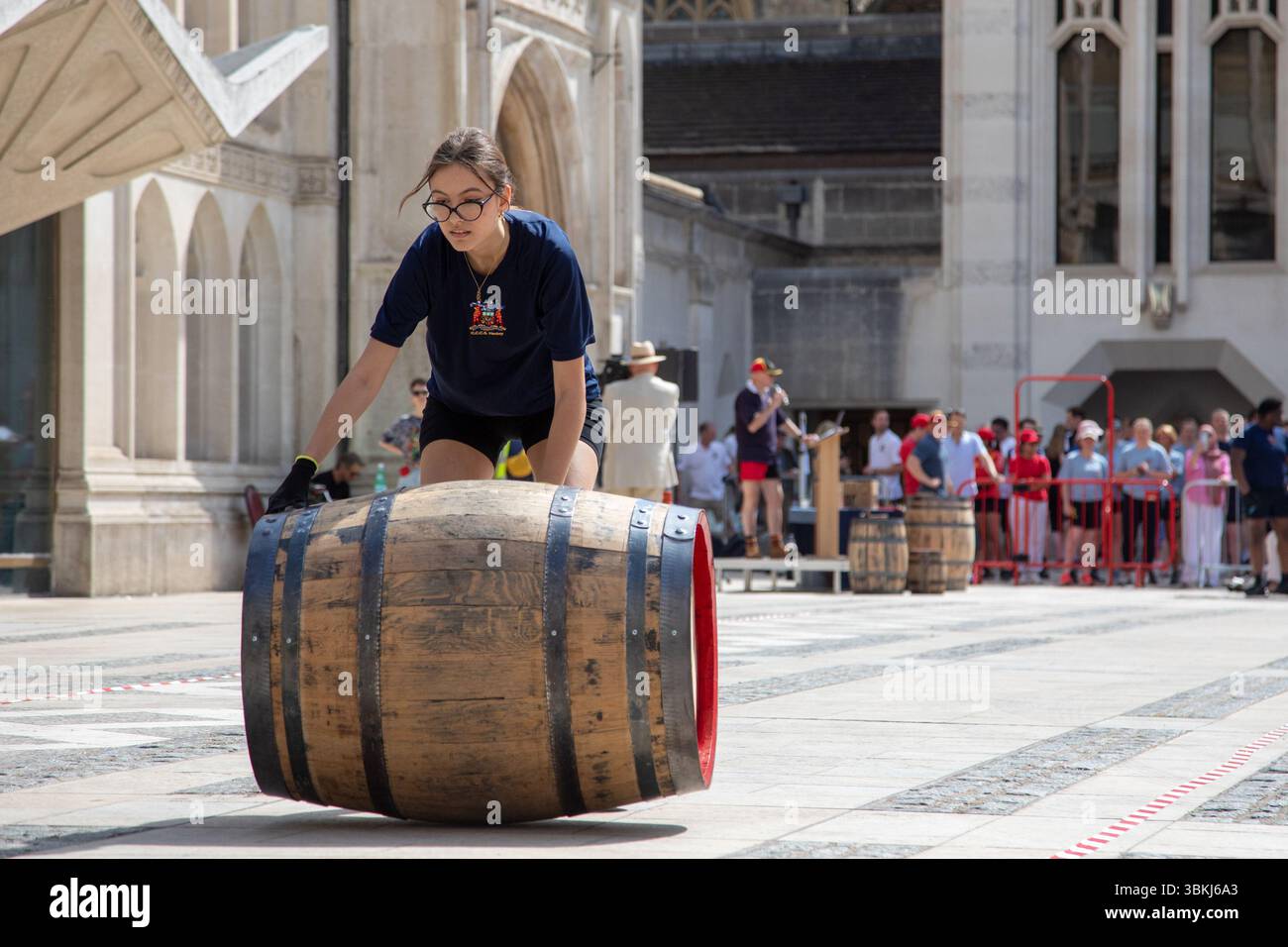 London, England, UK. 21st June 2025. The Worshipful Company of Coopers hosted the fourth annual Coopers’ Cask Race in Guildhall Yard, where 26 teams, including livery companies, schools, uniformed services, and Yeoman Warders, competed in a lively barrel-rolling celebration. Credit:Kiki Streitberger/Alamy Live News Stock Photo