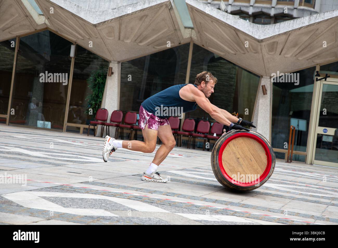 London, England, UK. 21st June 2025. The Worshipful Company of Coopers hosted the fourth annual Coopers’ Cask Race in Guildhall Yard, where 26 teams, including livery companies, schools, uniformed services, and Yeoman Warders, competed in a lively barrel-rolling celebration. Credit:Kiki Streitberger/Alamy Live News Stock Photo