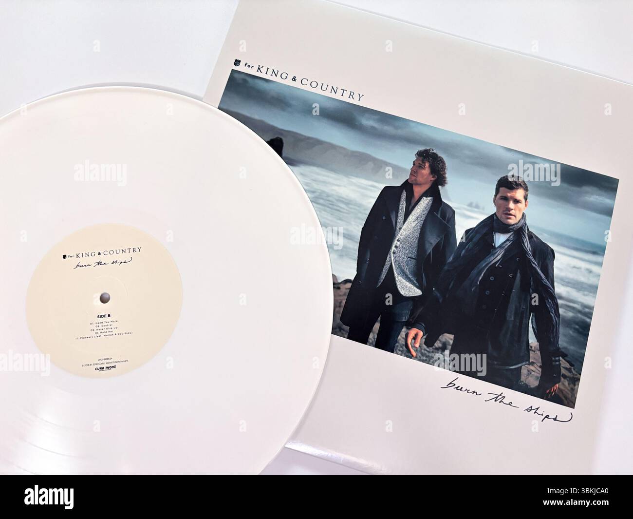 For King & Country's Burn the Ships vinyl record, a striking white pressing album cover. Christian rock band. Stock Photo