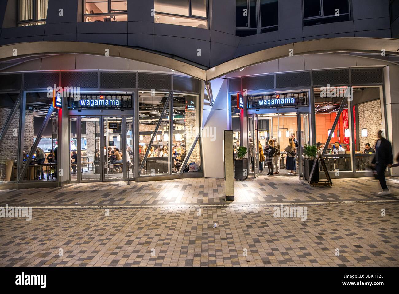 London, UK - September 14, 2023: Wagamama exterior logo, a popular British chain of pan asian restaurants based on Japanese food in Battersea at night Stock Photo