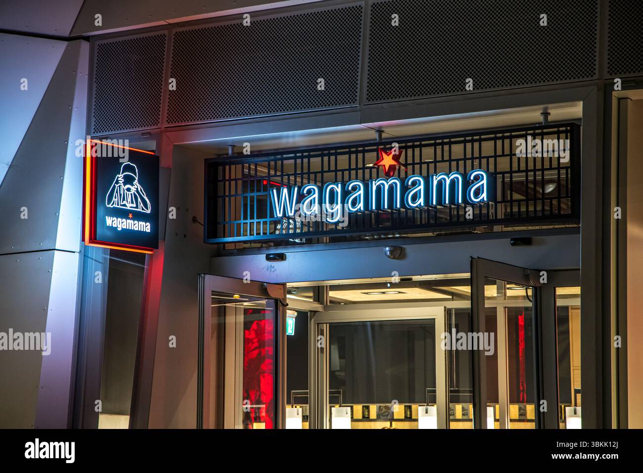 London, UK - September 14, 2023: Wagamama exterior logo, a popular British chain of pan asian restaurants based on Japanese food at night. Stock Photo