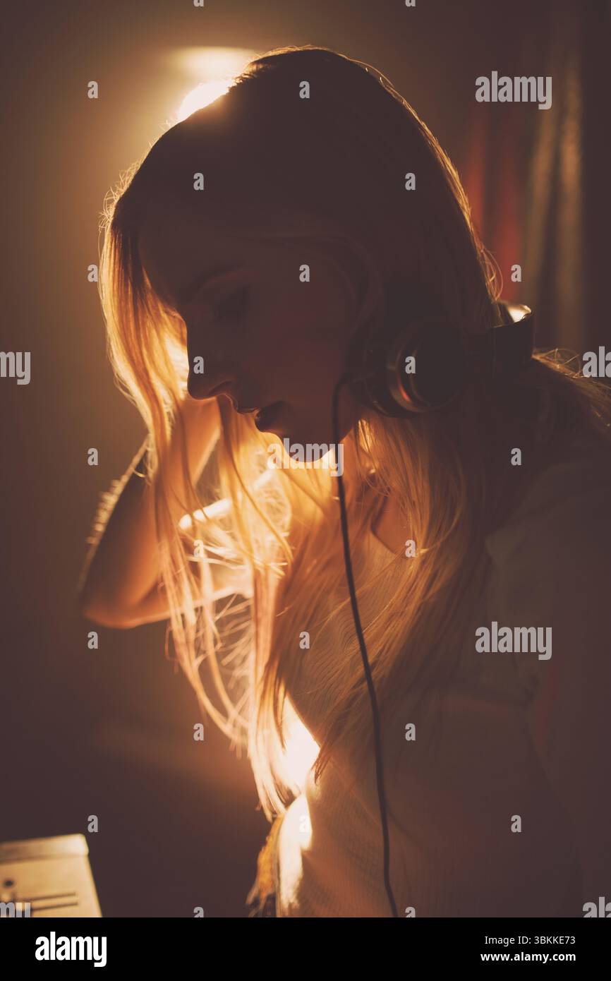 Side view of young woman in music studio Stock Photo