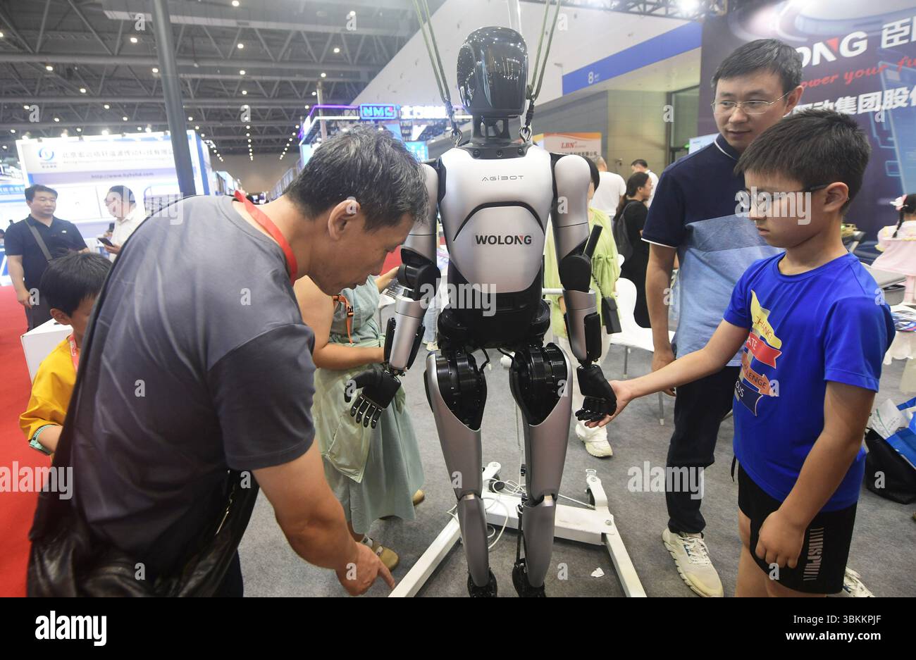 HANGZHOU, CHINA - JUNE 22, 2025 - A visitor is viewing humanoid robots ...